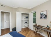 Thumbnail 21 of 27 - a bedroom with a bed and a desk